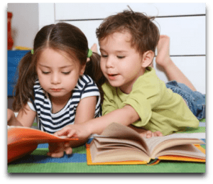 Two children are reading a book together.